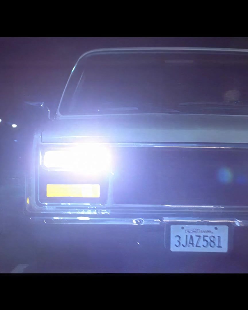 A night chase — truck and car headlights blazing at close quarters